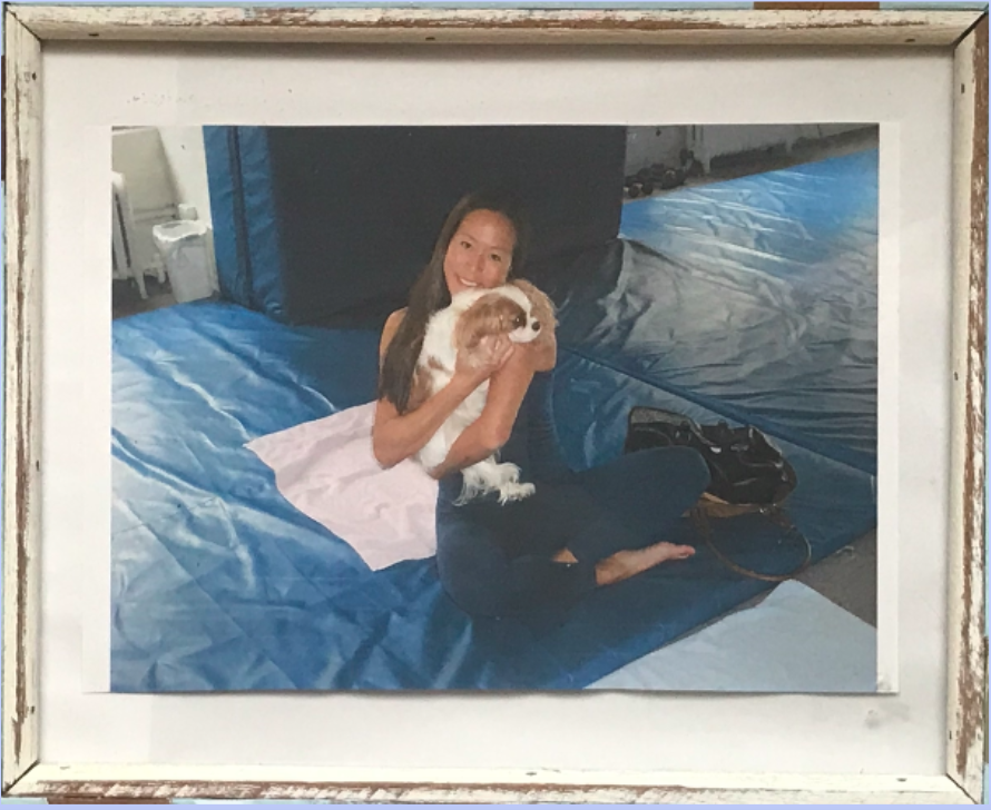 Christine holding a small dog at a gym in 2003